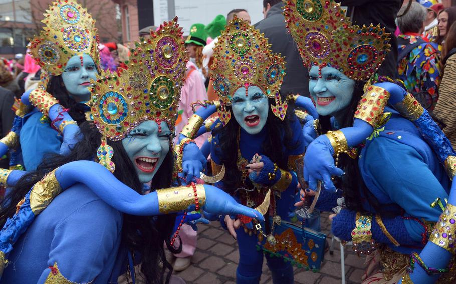 These marvelously costumed celebrants enjoy the fun before a steady drizzle began to fall on Altweiberfastnacht, or old women's carnival, on Schillerplatz in downtown Mainz, Germany, Thursday, Feb. 4, 2016.



