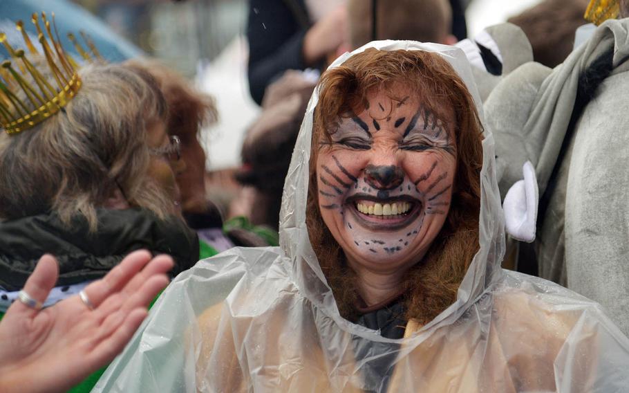 Supposedly cats don't like getting wet, but a steady drizzle didn't keep this one from having fun at Altweiberfastnacht, or old women's carnival, on Schillerplatz in downtown Mainz, Germany, Thursday, Feb. 4, 2016.

