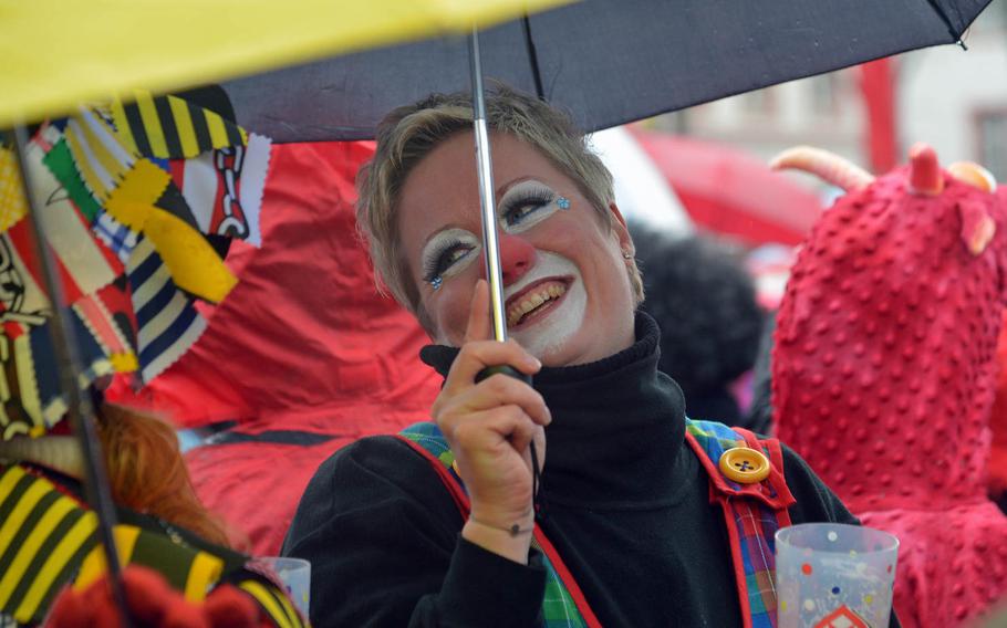 Despite a steady drizzle and cold wind, participants had a good time celebrating Altweiberfastnacht, or old women's carnival, on Schillerplatz in downtown Mainz, Germany, Thursday, Feb. 4, 2016.

