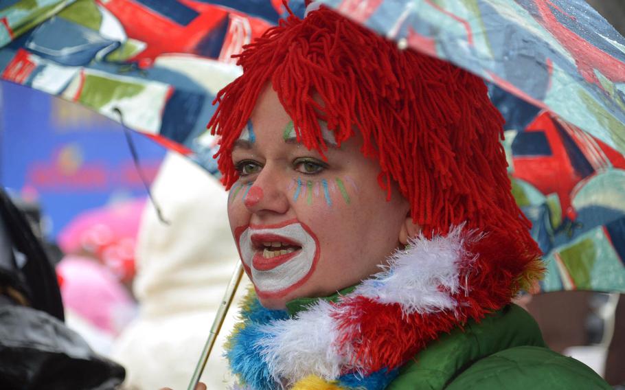 One colorful clown wasn't going to let rain and wind spoil her  Altweiberfastnacht, or old women's carnival, on Schillerplatz in downtown Mainz, Germany, Thursday, Feb. 4, 2016.


