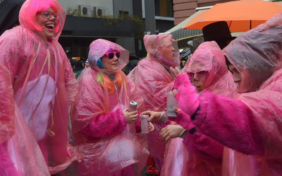 A group of pink ladies dance to the music during  Altweiberfastnacht, or old women's carnival, on Schillerplatz in downtown Mainz, Germany, Thursday, Feb. 4, 2016. The thousands of partygoers who turned out for the event didn't let a chill wind and steady drizzle spoil their fun.

