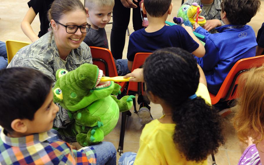 U.S. Air Force Master Sgt. Emily Jones, 39th Medical Operations Squadron dental flight chief, holds a puppet as children from the Incirlik Unit School demonstrate proper toothbrush technique Feb. 19, 2016, at Incirlik Air Base, Turkey. The Defense Department has announced on Tuesday, March 29, 2016, that it will start the evacuation all dependents, including some 270 schoolchildren, from the base for force-protection reasons.




