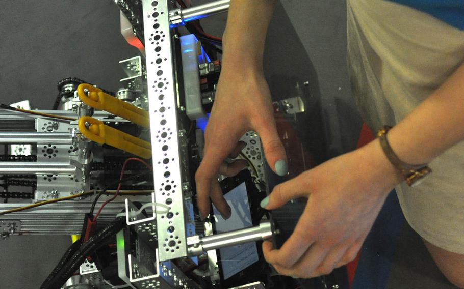 Lead programmer Julia Markel inserts an Android phone that serves as the robot's brain. Another Android phone allows club members to communicate with and control the robot.

