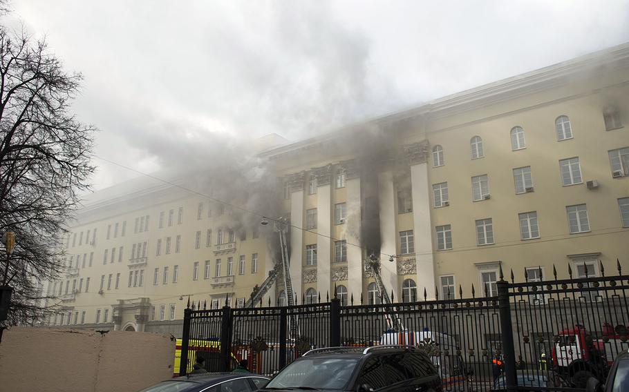 Firefighters work to put out a blaze at a building of Russian Defense Ministry in Moscow, Russia, Sunday, April 3, 2016. A building of the Russian Defense ministry is on fire in central Moscow with the fire brigade is on its way, the city’s law enforcement bodies told Russian news agency TASS on Sunday.