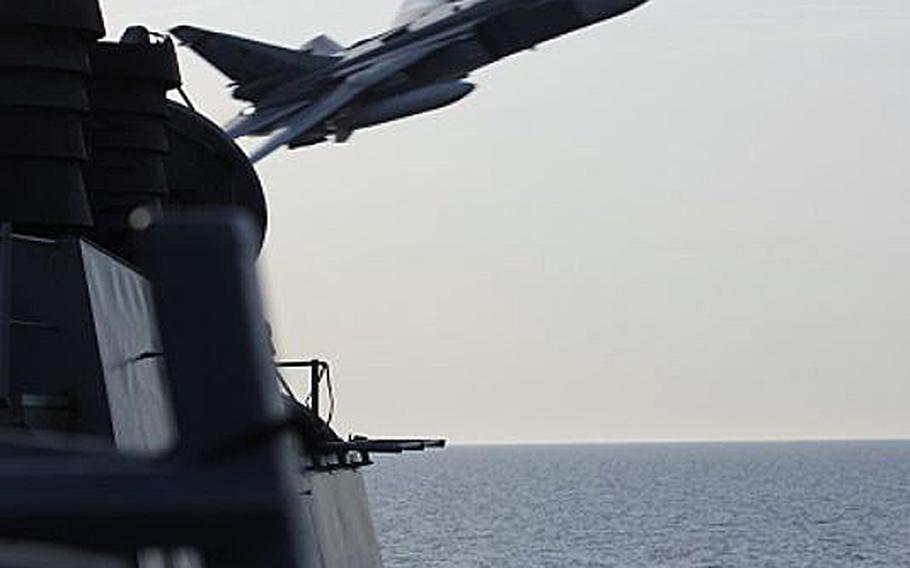 A Russian fighter jet passes in front of the USS Donald Cook as the ship was operating in the Baltic Sea on Tuesday, April 12, 2016.