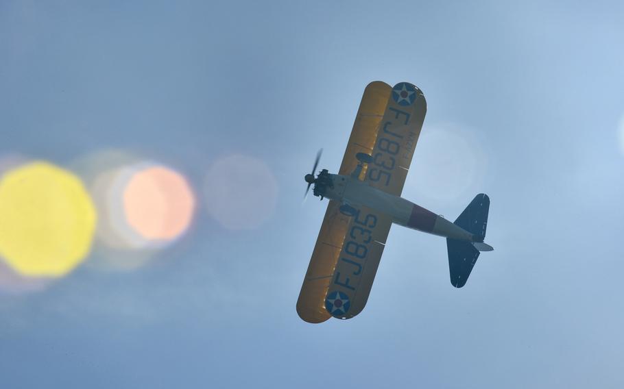 A World War I-era Stearman PT-17 biplane flies over the Lafayette Escadrille Memorial in Marnes-la-Coquette, France, April 20, 2016, during a ceremony honoring the 268 Americans who joined the French air force before the U.S. officially engaged in World War I.