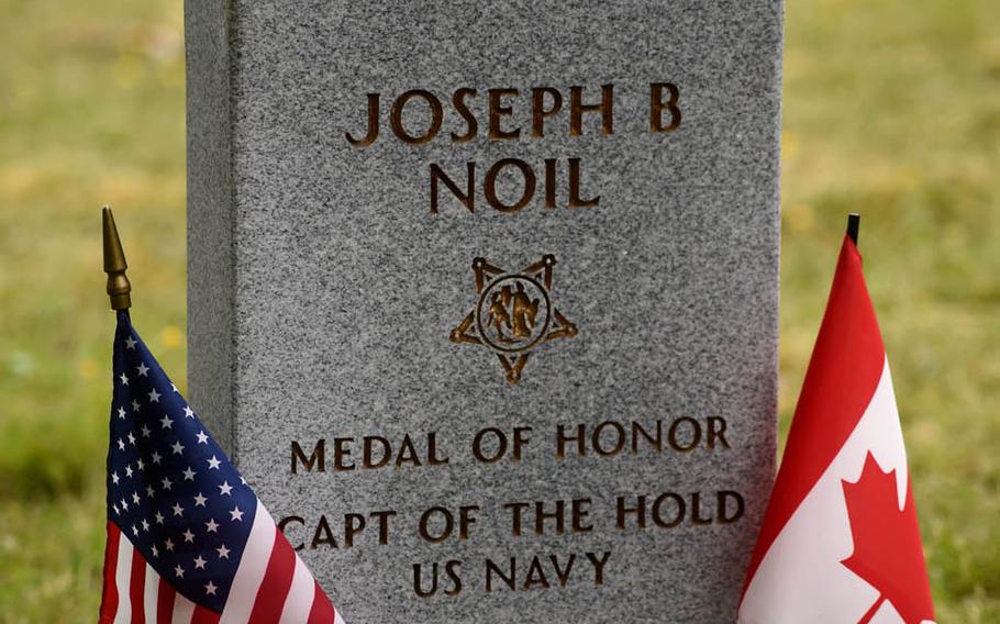 American and Canadian flags are placed at the new headstone of Medal of Honor recipient Joseph B. Noil during a ceremony Friday, April 29, 2016, at St. Elizabeths Hospital Cemetery in Washington, D.C.  Noil received the Medal of Honor while serving on USS Powhatan, but his headstone did not recognize his award because of a misprint on his death certificate.
