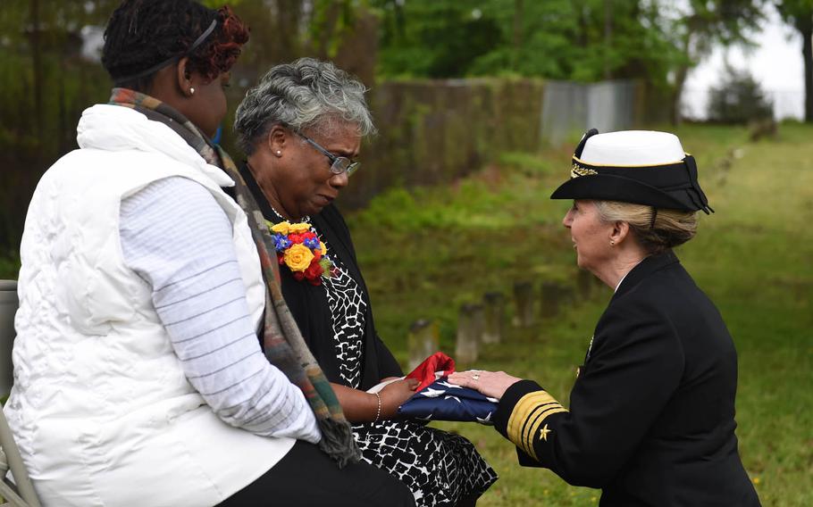 Chief of Navy Reserve Vice Adm. Robin Braun presents the American flag to Bernadette Maybelle Parks Ricks, great granddaughter of Medal of Honor recipient Joseph B. Noil, during a ceremony Friday, April 29, 2016, at St. Elizabeths Hospital Cemetery in Washington, D.C.  Noil received the Medal of Honor while serving on USS Powhatan, but his headstone did not recognize his award because of a misprint on his death certificate.