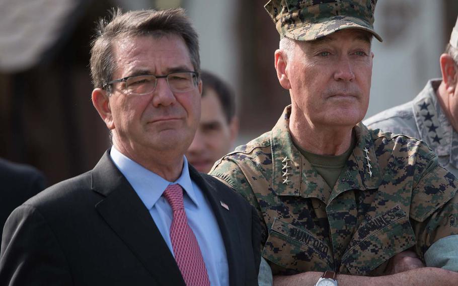 Defense Secretary Ash Carter and Chairman of the Joint Chiefs of Staff Gen. Joseph Dunford Jr. wait to begin the EUCOM change of command ceremony at Patch Barracks in Stuttgart, Germany, Tuesday, May 3, 2016.  