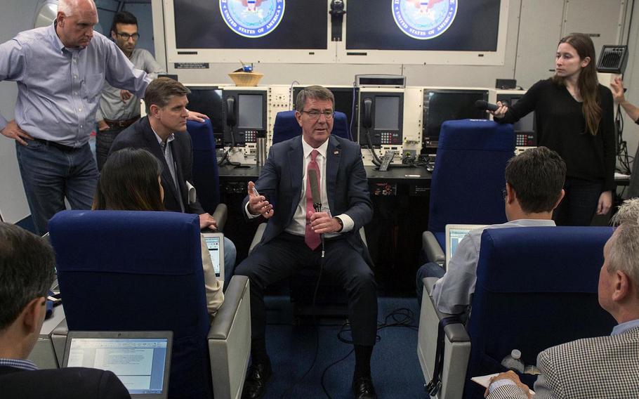 Defense Secretary Ash Carter speaks with reporters aboard a military aircraft as they fly to Brussels, June 13, 2016, to attend a NATO meeting of defense ministers.
