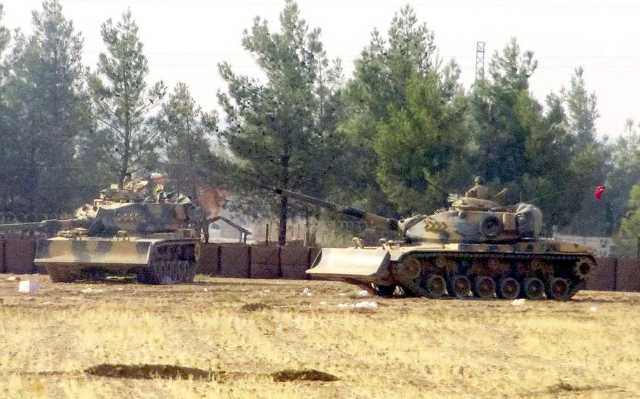 Turkish army tanks are stationed near the border with Syria, in Karkamis, Turkey, Wednesday, Aug. 24, 2016.