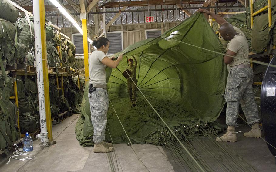 U.S. soldiers inspect the inside of a G-11 cargo parachute at Fort Bragg, N.C. on July 30, 2015. A similarly-sized parachute was cut loose near the German town of Hutten during a training mishap aboard a C-130 cargo plane passing overhead on Friday, September 9, 2016.
