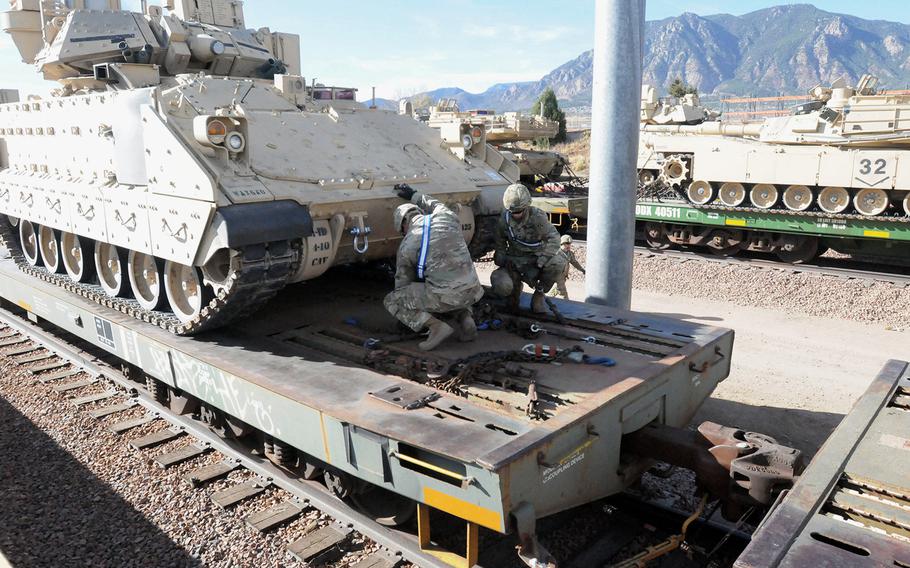 A Fort Carson-based M2A3 Bradley fighting vehicle crew secure their vehicle to a rail car at Fort Carson, Colorado, on Nov. 15, 2016.