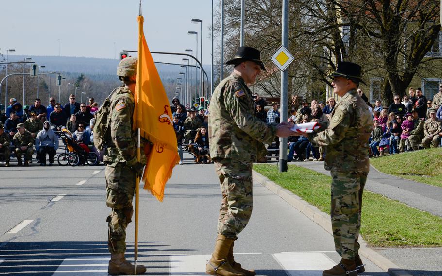U.S. Army Col. Patrick J. Ellis, right, commander of the 2nd Cavalry Regiment, presents a Regimental Deployment Flag to U.S. Army Lt. Col. Steven Gventer, commander of the 2nd Squadron, 2nd Cavalry Regiment, at the Battle Group Poland Departure Ceremony, March 25, 2017, in Vilseck, Germany.