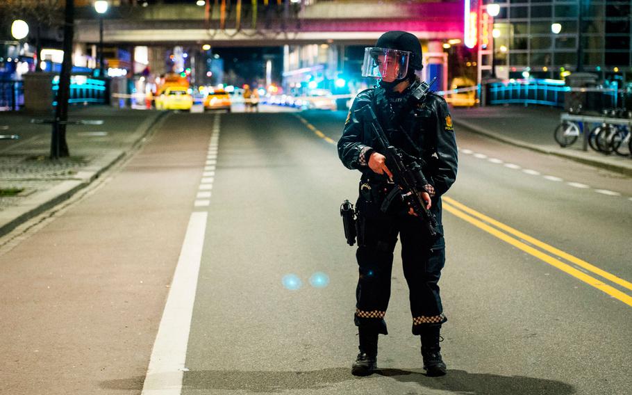 An officer stands guard as police cordon off a large area around a subway station on a busy commercial street Saturday night, April 8, 2017, after finding what they described as a "bomb-like" device, in Oslo, Norway. The official police Twitter account said one man has been arrested and Police Chief Vidar Pedersen said police were working to disarm it.