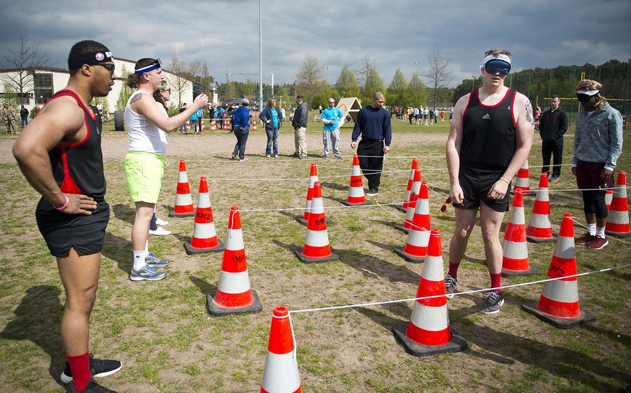 Members of the Shady 80s, a 37th Airlift Squadron team, complete the blindfolded portion of the obstacle course during the annual Courage, Leadership, Education, Advocacy and Respect Challenge at Ramstein Air Base, Germany, on Friday, April 14, 2017.
