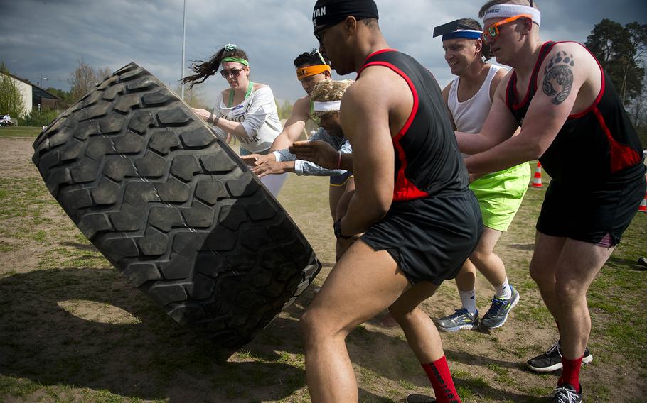 The Shady 80s, a 37th Airlift Squadron team, flip a tire during the annual Courage, Leadership, Education, Advocacy and Respect Challenge at Ramstein Air Base, Germany, on Friday, April 14, 2017.
