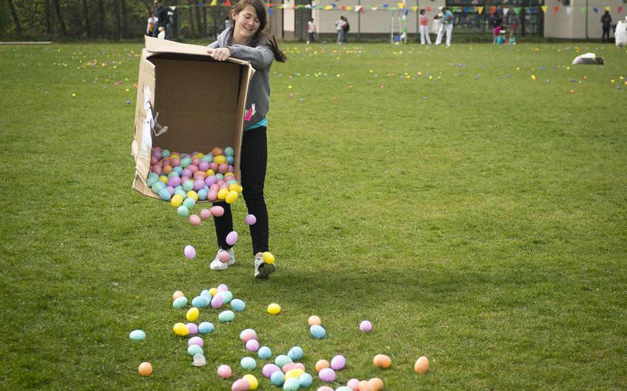 Carly Acopan, from the 86th Force Support Squadron, spreads eggs during the Easter Egg Hunt at Ramstein Air Base, Germany, on Saturday, April 15, 2017. The plastic eggs were filled with candy, toys and tickets that could be turned in for bigger prizes.