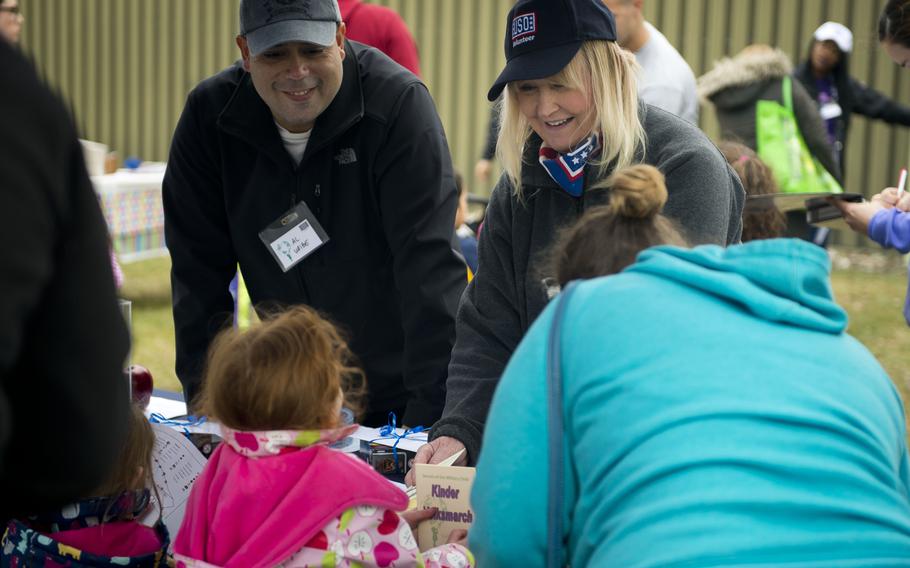 Janet Burgard, right, and Al Uribe, from USO Kaiserslautern, hand out Kinder Volksmarch passports at Rhine Ordnance Barracks, Germany, on Saturday, April 22, 2017. Participants got stamps at the booths to score points.


