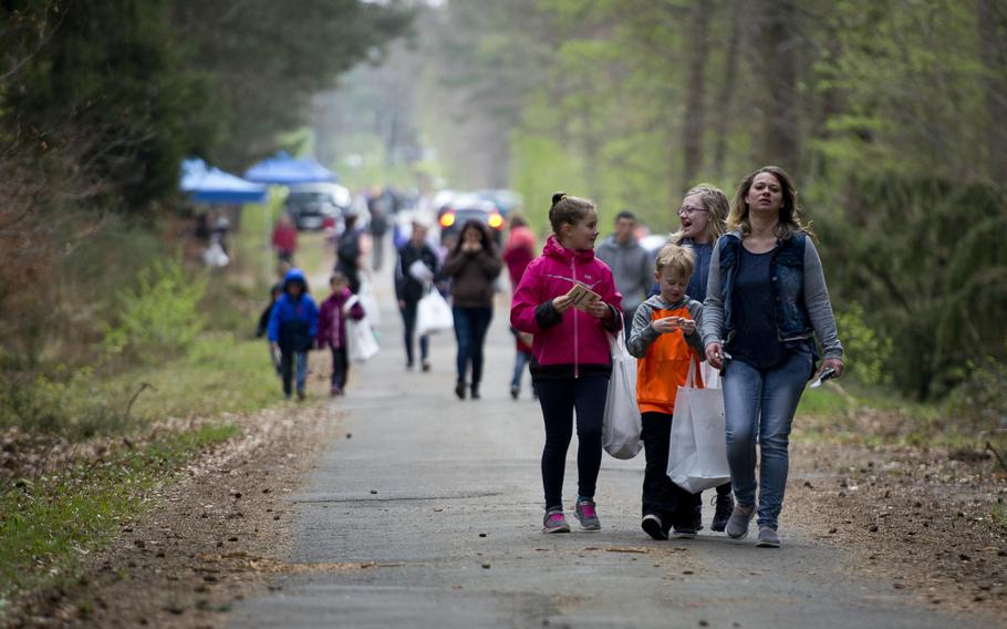 Families walk down a trail during the Kinder Volksmarch at Rhine Ordnance Barracks, Germany, on Saturday, April 22, 2017.


