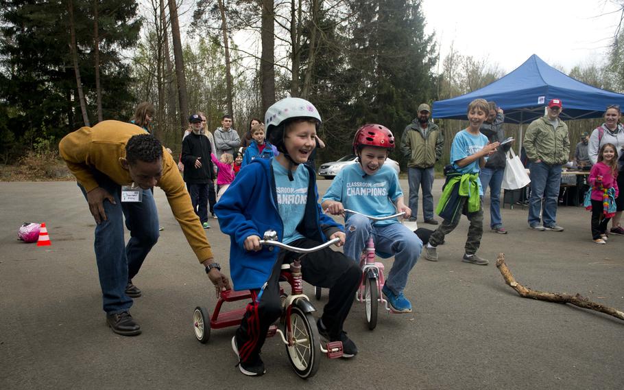 Grant Parry, right, races Jacob Barnes as Army Master Sgt. Saimbert Addley helps during the Kinder Volksmarch at Rhine Ordnance Barracks, Germany, on Saturday, April 22, 2017. Addley is from the 21st Theater Sustainment Command.