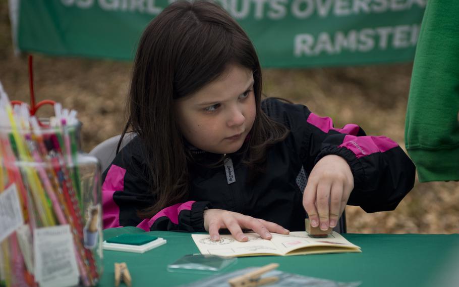 Mary Wolfe stamps a passport at the U.S. Girl Scouts Overseas Ramstein-Sembach tent during the Kinder Volksmarch at Rhine Ordnance Barracks, Germany, on Saturday, April 22, 2017.


