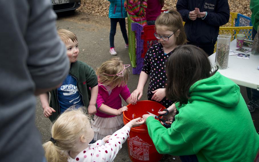 Children make a seed packet at the U.S. Girl Scouts Overseas Ramstein-Sembach tent during the Kinder Volksmarch at Rhine Ordnance Barracks, Germany, on Saturday, April 22, 2017. The march featured many Earth Day-themed activities at several of the tents.

