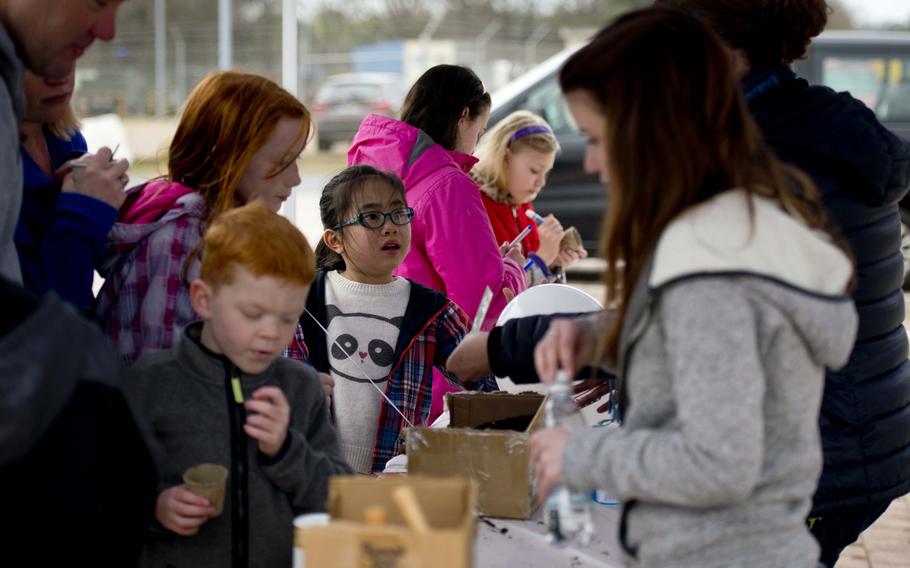 Children put seeds in small pots during the Kinder Volksmarch at Rhine Ordnance Barracks, Germany, on Saturday, April 22, 2017.

