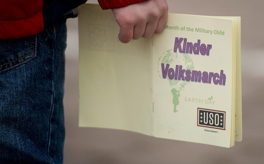 A child waits to have his passport stamped during the Kinder Volksmarch at Rhine Ordnance Barracks, Germany, on Saturday, April 22, 2017.
