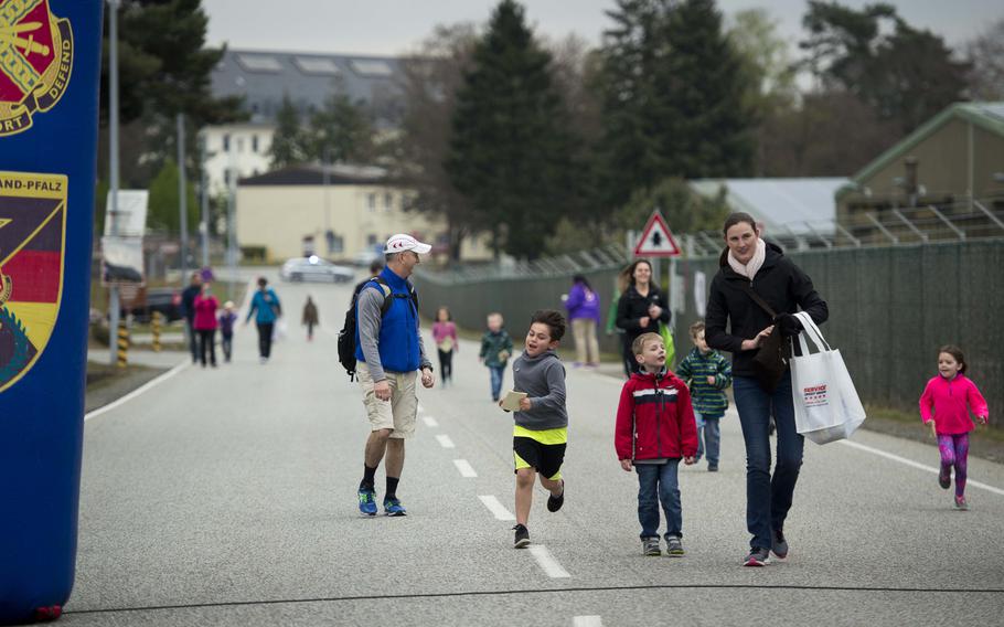 Participants cross the Kinder Volksmarch finish line at Rhine Ordnance Barracks, Germany, on Saturday, April 22, 2017. The march was 2 miles and featured tents along the way with activities, crafts and games.