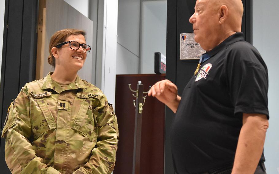 Medal of Honor recipient Gary Littrell talks with Capt. Allison Anderson on May 12, 2017, during a tour of the NATO Allied Joint Force Command in Lago Padria, Italy.