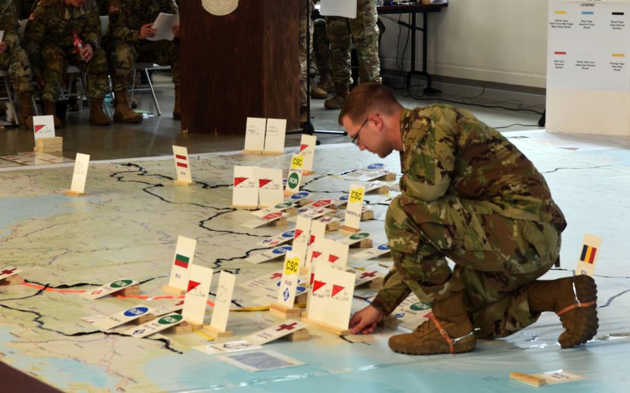 A U.S. soldier moves markers representing soldiers of U.S., allied and partner nations along their intended route to the Black Sea during the rehearsal of concepts drill for Exercise Saber Guardian at Vilseck Germany, Friday, June 9, 2017. 
