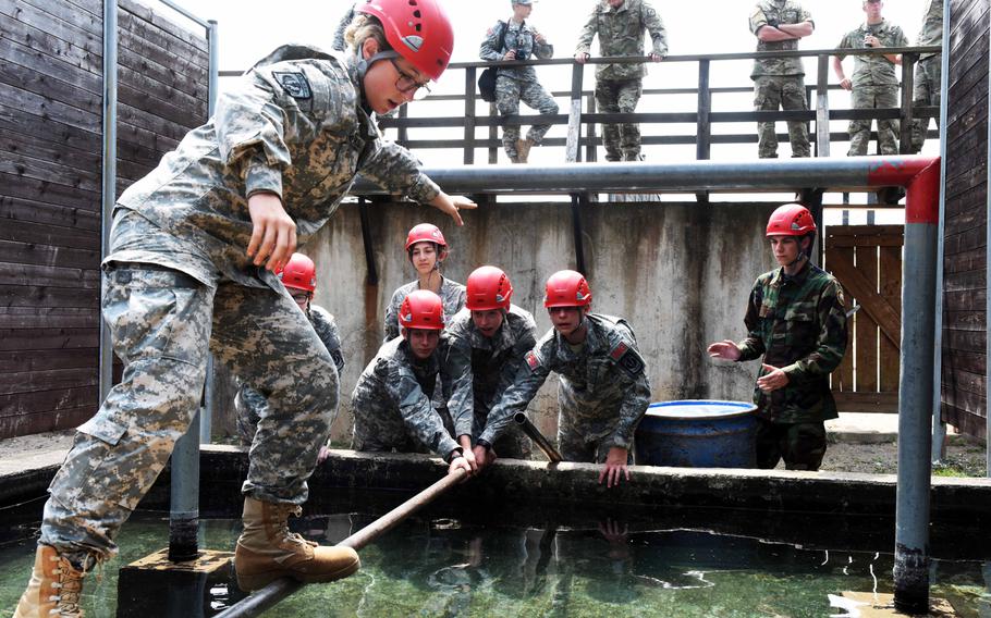 JROTC cadets carefully maneuver an obstacle at the leadership reaction course, Thursday, June 22, 2017, at Grafenwoehr, Germany.