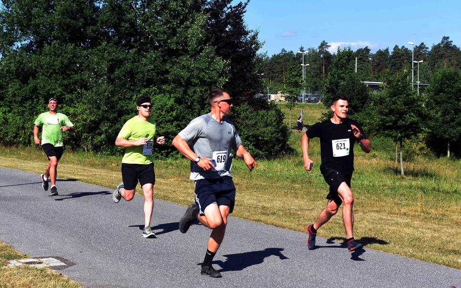 Runners motivate each other during the Army 10-miler qualification run at Grafenwoehr, Germany, Saturday, June 24, 2017. 

