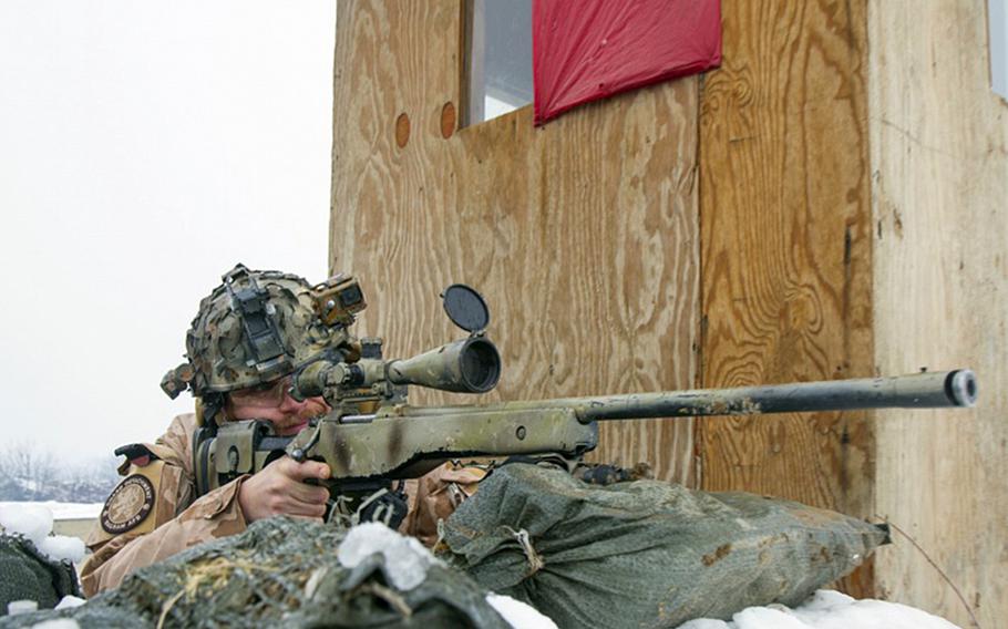 A Czech Republic sniper pulls security duty during a supply delivery to the people of Parwan province, Afghanistan, in January 2017. 