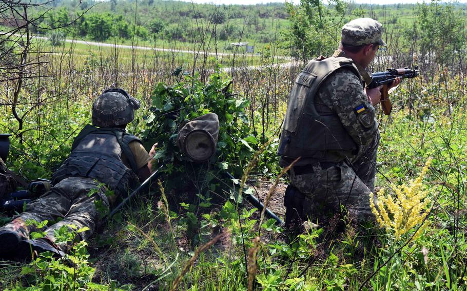 Two Ukrainian soldiers guard a position during a mock defensive battle with the Joint Multinational Training Group-Ukraine, in Yavoriv, Ukraine, June 29, 2017. 
