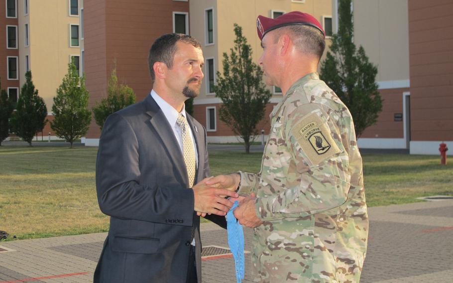 Former Staff Sgt. Sal Giunta gives his Medal of Honor to 173rd Airborne Brigade Commander Col. Greg Anderson during a ceremony marking a new memorial to the brigade's 18 Medal of Honor awardees on July 6, 2017, in Vicenza, Italy. Giunta, who was awarded the medal in 2010, said it belonged to the brigade.