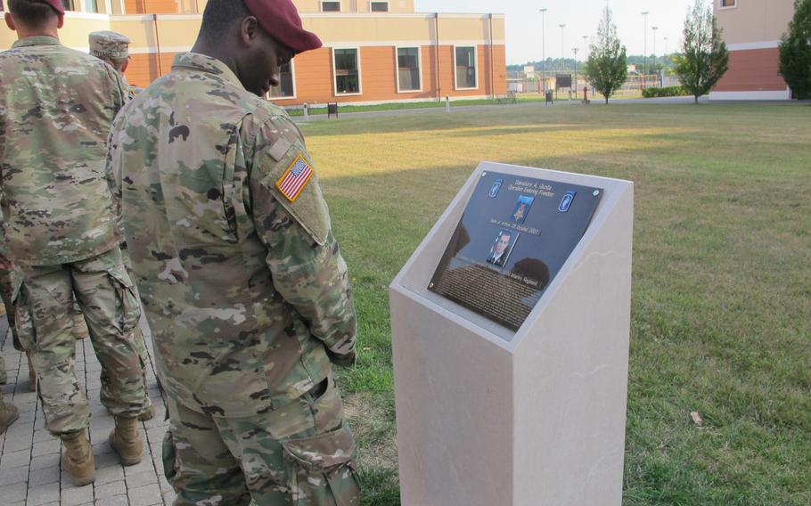 First Lt. Alexander Ombori reads Sal Giunta's plaque at a new memorial to the brigade's 18 Medal of Honor awardees on July 6, 2017, in Vicenza, Italy.