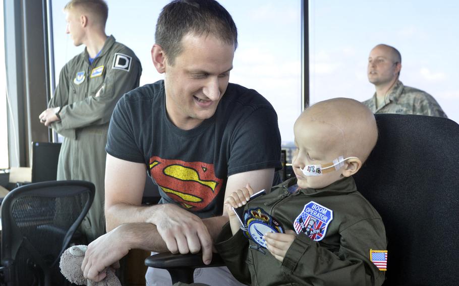 Martin Davidson with his 5-year-old son Jay in the control tower at RAF Mildenhall, England, Friday, July 7, 2017. The 100th Air Refueling Wing invited the local boy, who was diagnosed with brain cancer in January, to become an honorary pilot for the day.