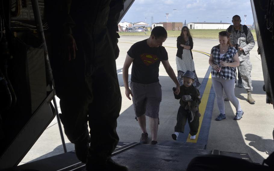 Martin Davidson leads his 5-year-old son Jay up the ramp of a CV-22 Osprey during a tour at RAF Mildenhall, England, Friday, July 7, 2017. 