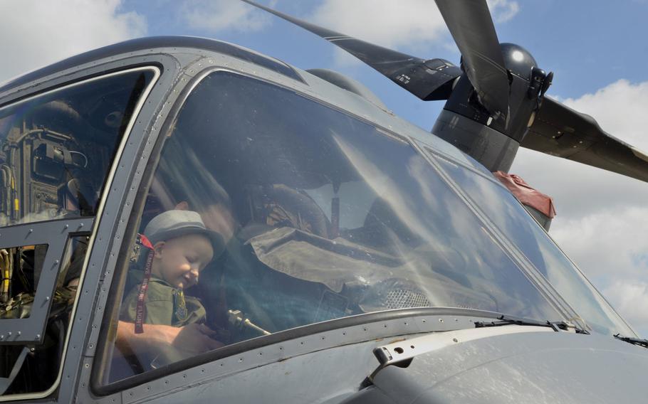 Martin Davidson sits with his 5-year-old son Jay in the cockpit of a CV-22 Osprey during a tour at RAF Mildenhall, England, Friday, July 7, 2017. The 100th Air Refueling Wing invited the local boy, who was diagnosed with brain cancer on January 5, 2017, to become an honorary pilot for the day.