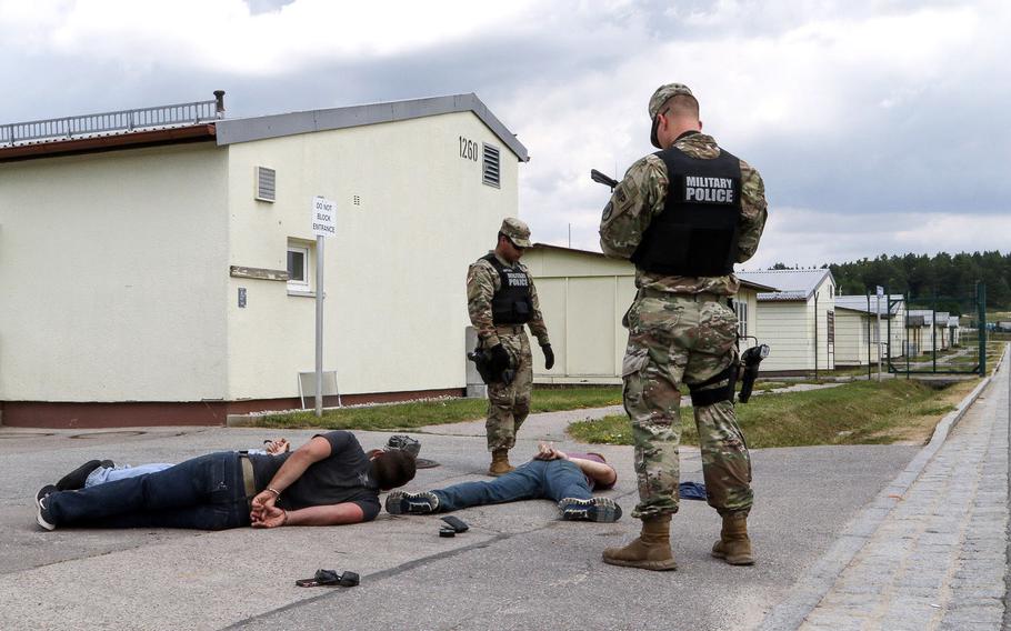 Military Police of the 591st MP Company out of Fort Bliss, Texas, stand watch over apprehended suspects during a KFOR 23 mission rehearsal exercise training scenario at the Joint Multinational Readiness Center in Hohenfels, Germany, Tuesday, July 4, 2017.