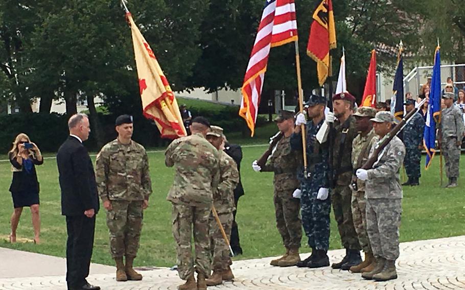 Col. Glenn Dickenson and Col. Neal A. Corson take part in the passing of the flag during a change-of-command at the Army's garrison in Stuttgart, Germany, Wednesday, July 12, 2017. Corson took command of a garrison that is home to 24,000 Americans. 

