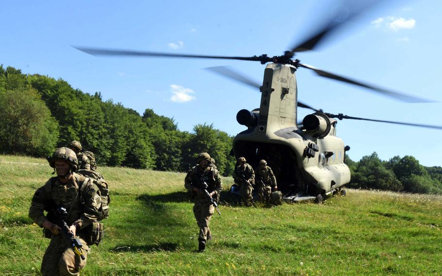 U.S. and British cadets from West Point and the Royal Military Academy Sandhurst run out of a CH-47 Chinook helicopter during the exercise Dynamic Victory in Hohenfels, Germany, Thursday, July 13, 2017. 

