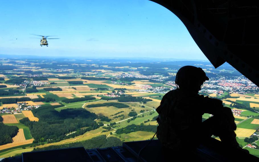 Spc. Luis Del Valle, a crew chief with the 1-214th Aviation Regiment, observes the view from the back of a CH-47 Chinook during the exercise Dynamic Victory, Thursday, July 13, 2017, in Grafenwoehr, Germany. 
