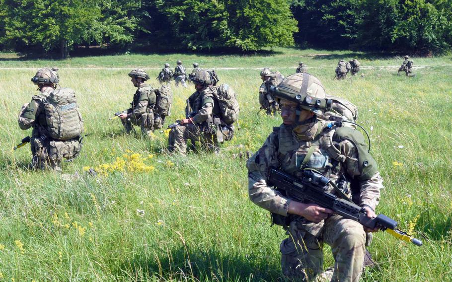 U.S. and British cadets secure the area after landing onto a field during the exercise Dynamic Victory, Thursday, July 13, 2017, in Hohenfels, Germany. 