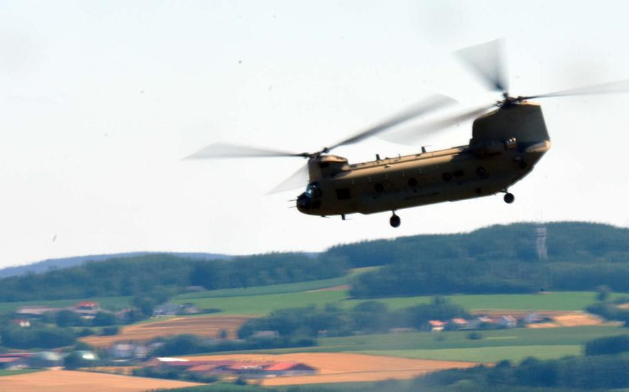 Soldiers with the U.S. Army's  1-214th Aviation Regiment fly a CH-47 Chinook loaded with U.S. and British cadets during the exercise Dynamic Victory, Thursday, July 13, 2017, in Grafenwoehr, Germany. 