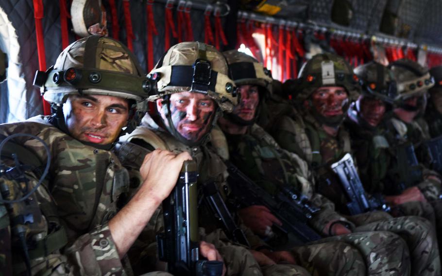 Cadets from the Royal Military Academy Sandhurst look out of the back of a U.S. Army CH-47 Chinook, during the exercise Dynamic Victory, Thursday, July 13, 2017, at Grafenwoehr, Germany