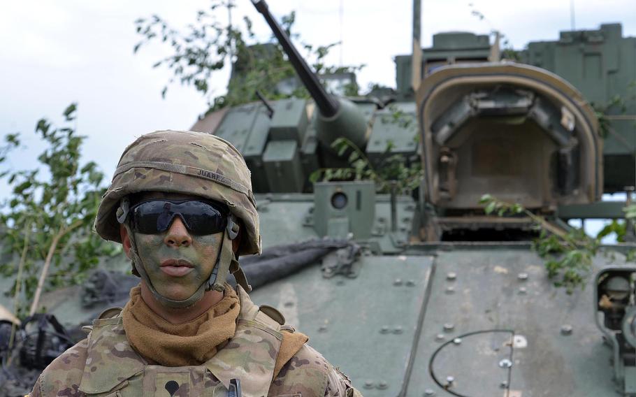 Spc. Martin Juarez stands in front of a Bradley Fighting Vehicle following a live-fire demonstration at the Center for Joint National Training in Cincu, Romania, Saturday, July 15, 2017. The demonstration was part of the U. S. Army Europe-led exercise Saber Guardian 2017.