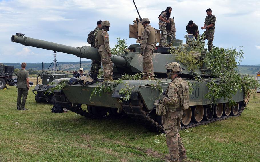 Members of the media and soldiers from other countries check out an U.S. Army M1A2 Abrams Tank of the 3rd Armored Brigade Combat Team, 4th Infantry Division following a live-fire demonstration at the Center for Joint National Training in Cincu, Romania, Saturday, July 15, 2017. The demonstration was part of the U. S. Army Europe-led exercise Saber Guardian 2017.